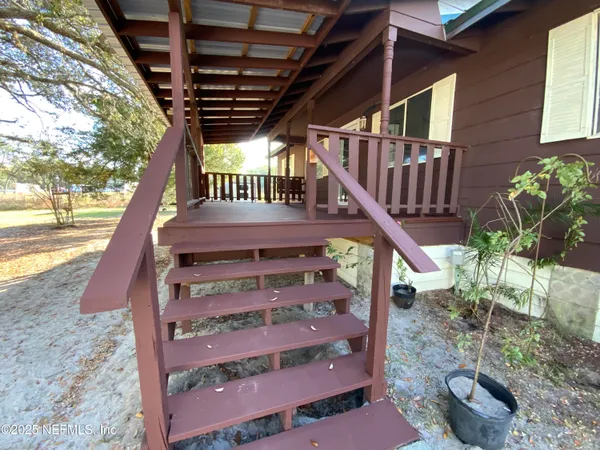 a view of deck with patio and wooden fence