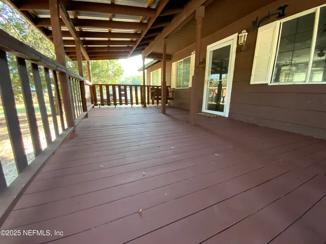 a view of porch with furniture and floor to ceiling window