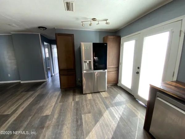 a view of a hallway with wooden floor and stairs