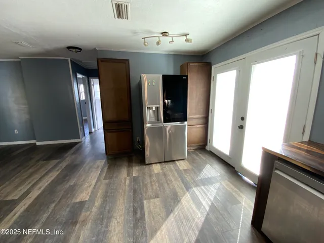 a view of a hallway with wooden floor and stairs