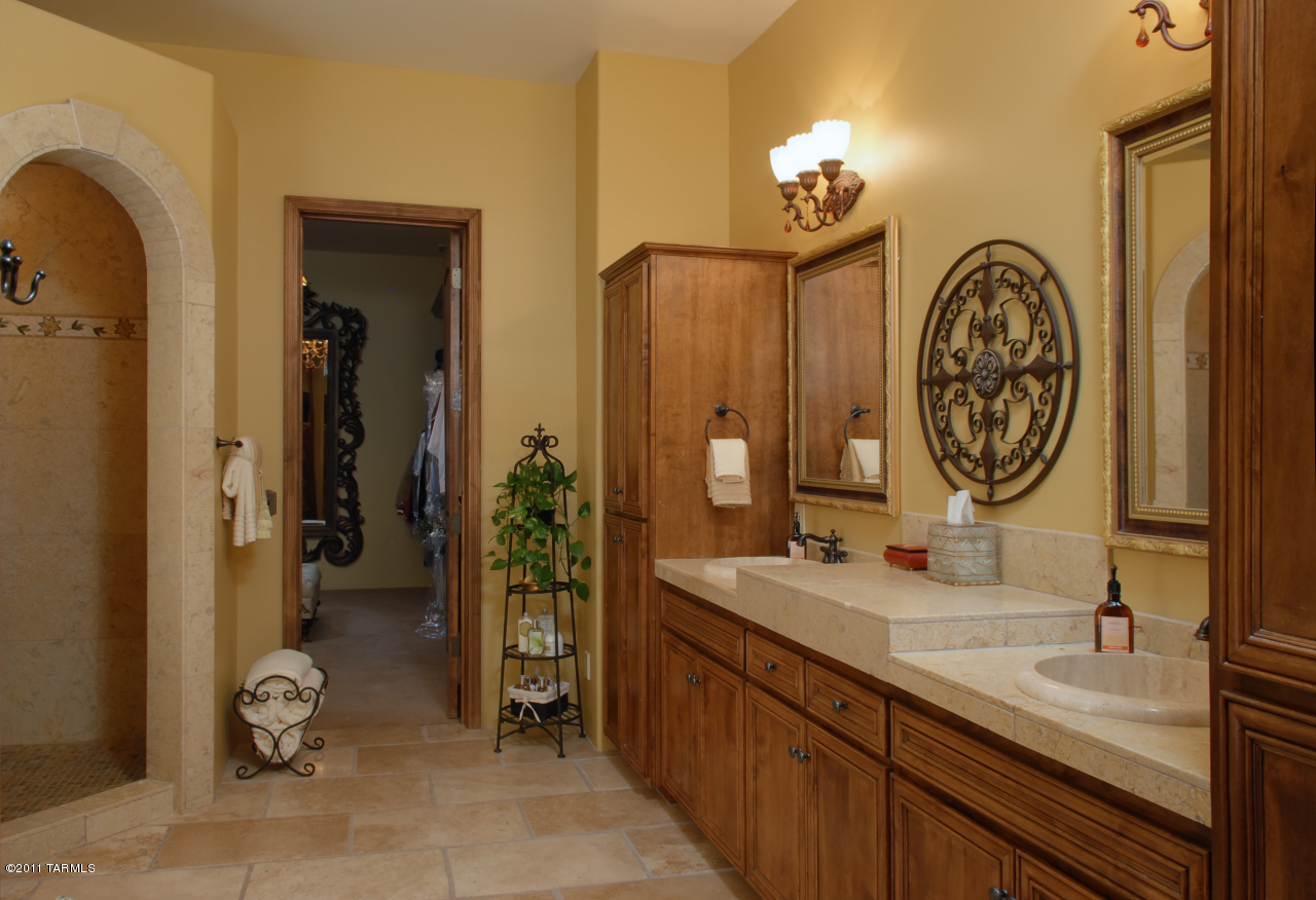 2188 East Buck Ridge Place Oro Valley, AZ 85737 - Photo 14 of 22 a bathroom with a double vanity sink and a mirror