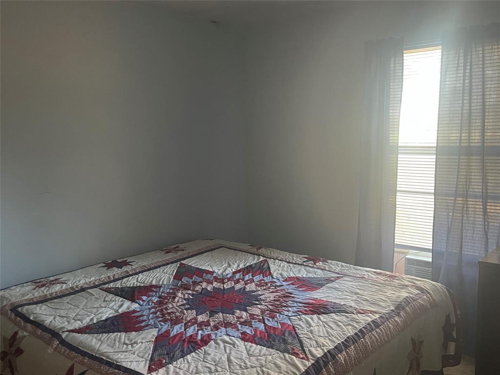 754 Stone Haven Road Idabel, OK 74745 - Photo 9 of 13 a bedroom with a bed and a window