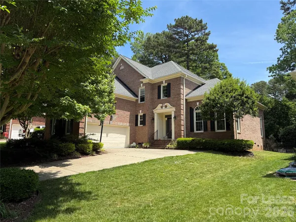 a front view of house with yard and green space