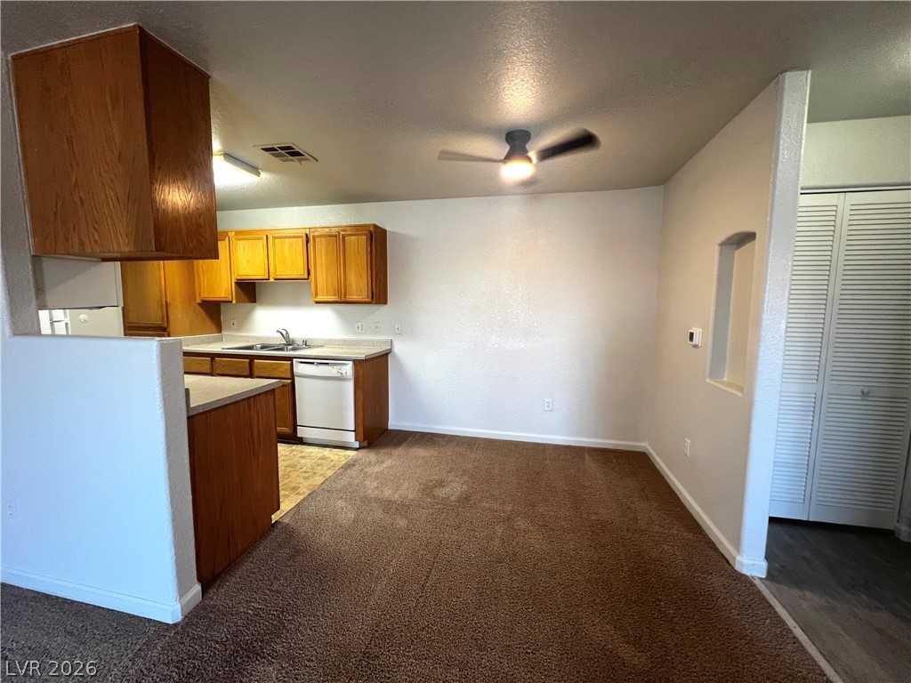 4730 East Craig Road, Unit 2104 Las Vegas, NV 89115 - Photo 4 of 20 A functional kitchen flows into a cozy carpeted dining or living area, ready for your personal touch.