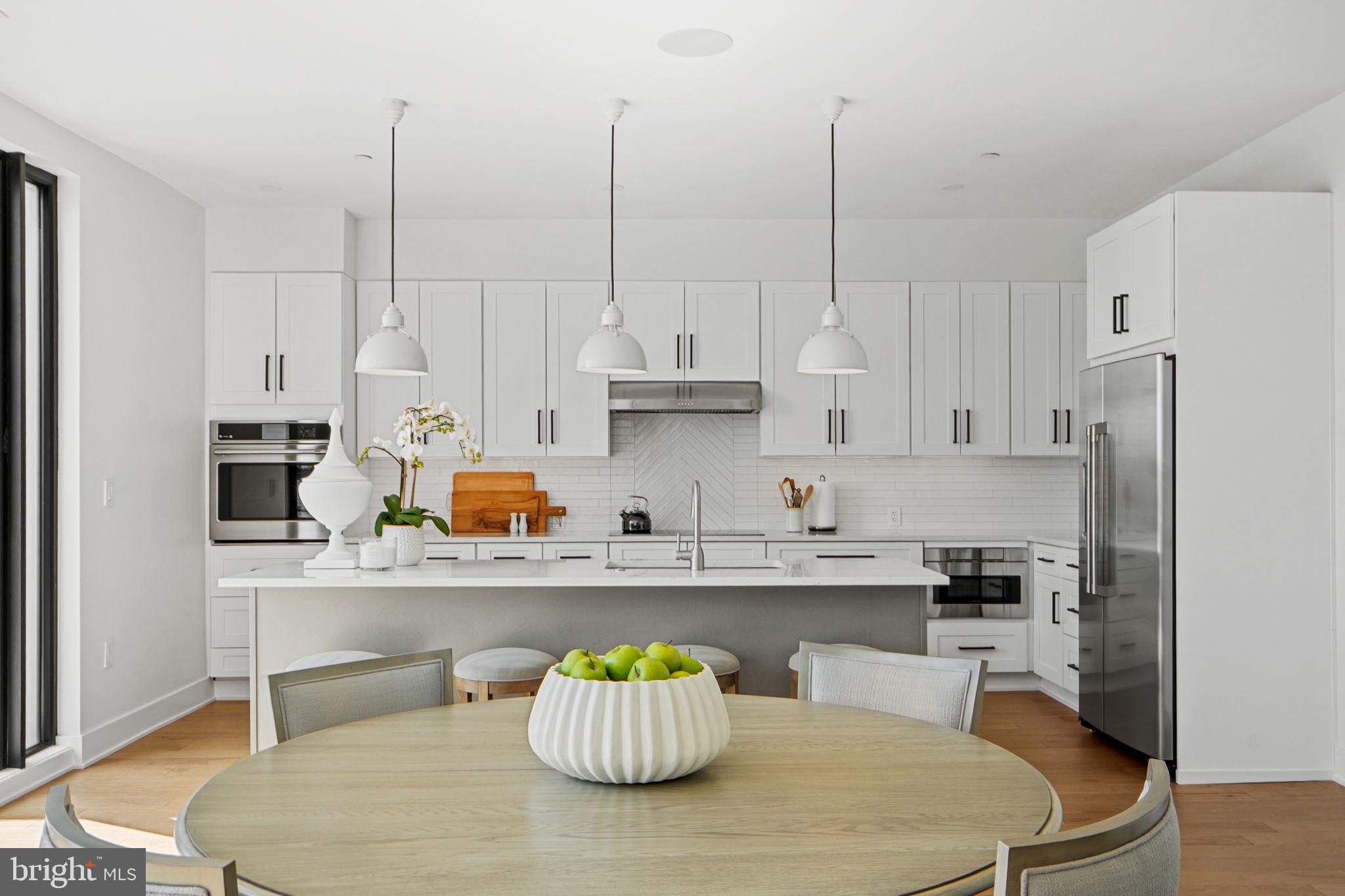 210 East 2nd Street, Unit 402 Frederick, MD 21701 - Photo 18 of 71 a kitchen with stainless steel appliances granite countertop a sink a stove a refrigerator and white cabinets