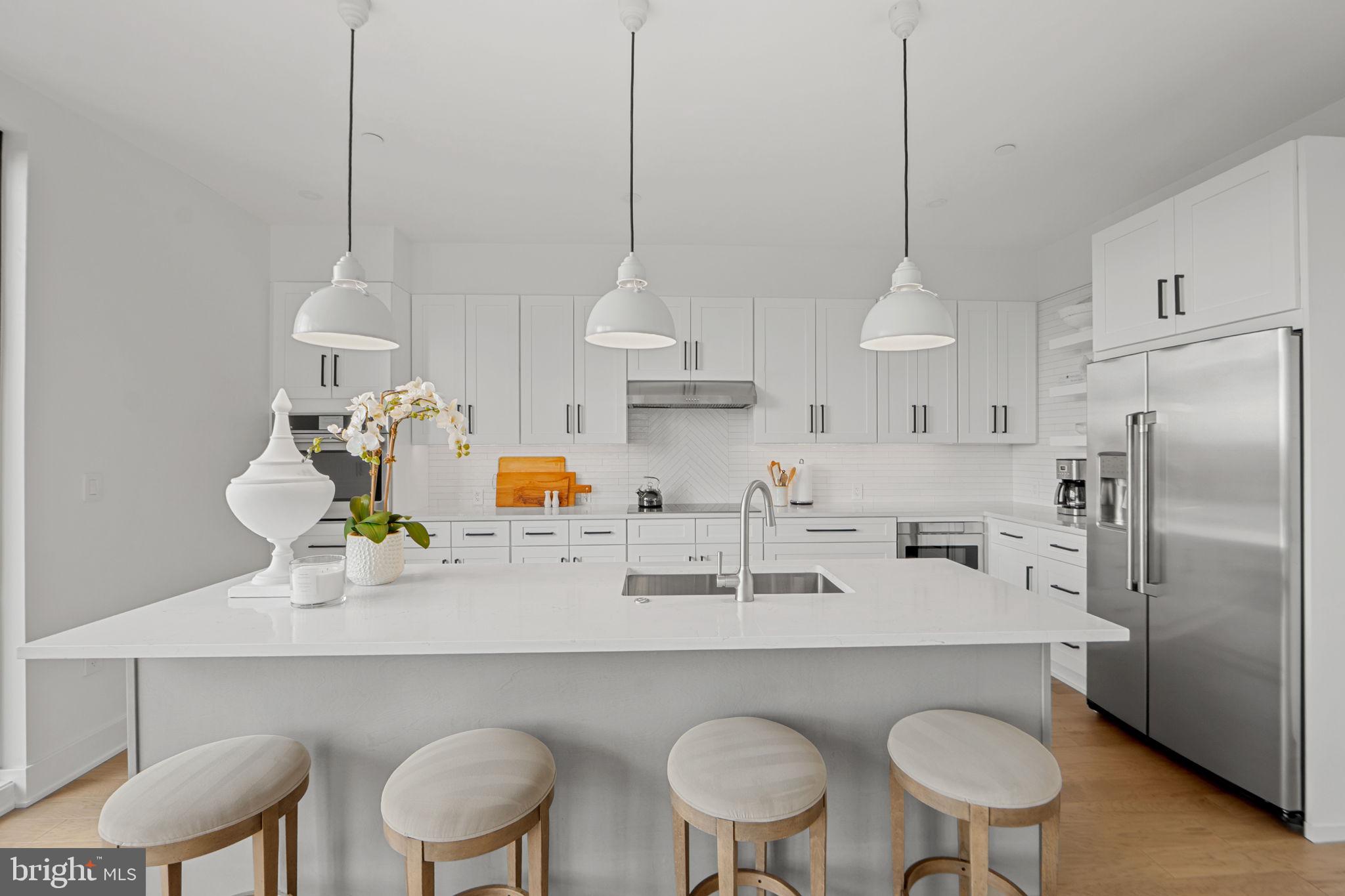 210 East 2nd Street, Unit 402 Frederick, MD 21701 - Photo 21 of 71 a kitchen with refrigerator a sink and cabinets