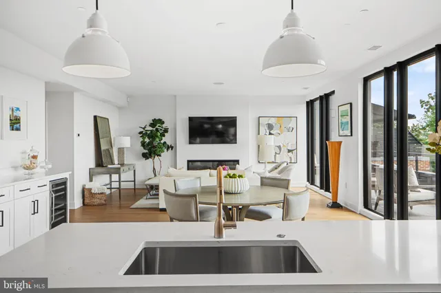 a balcony view with a glass top table and chairs