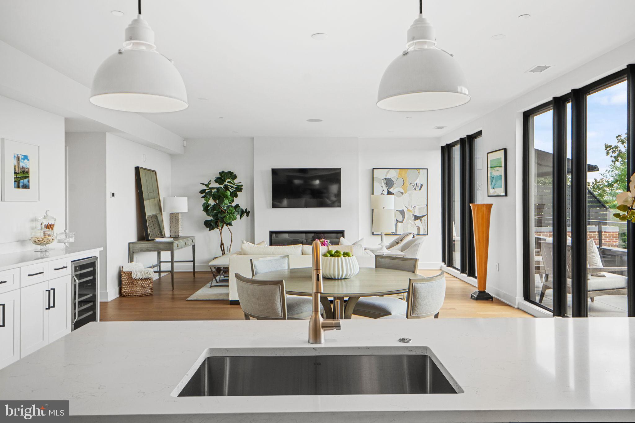 210 East 2nd Street, Unit 402 Frederick, MD 21701 - Photo 24 of 71 a living room with furniture a large window and a chandelier