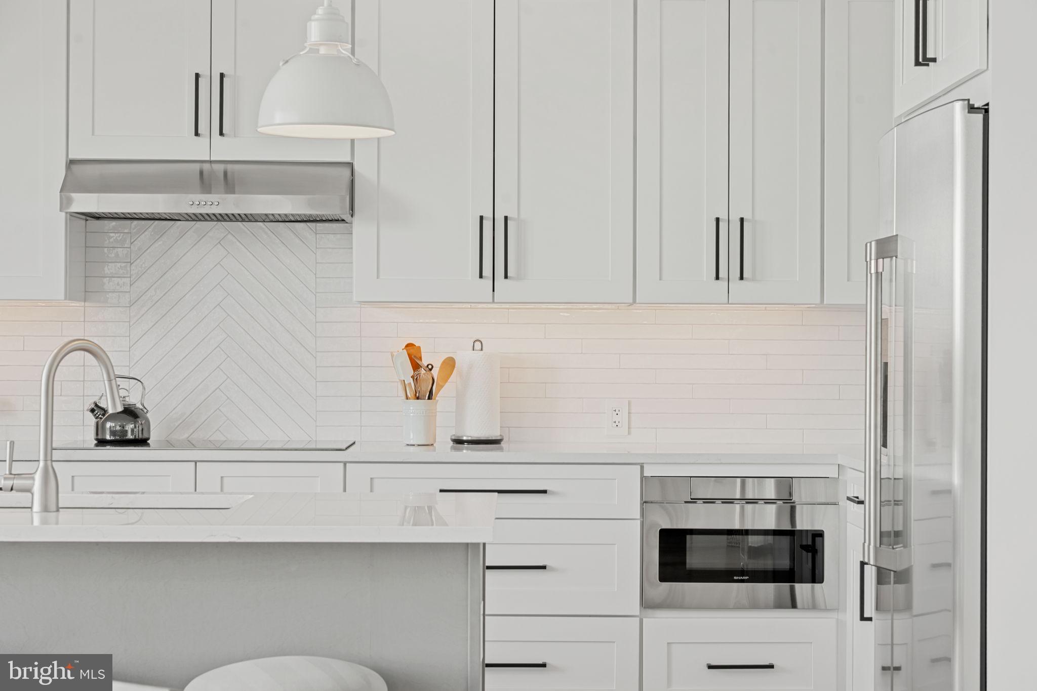 210 East 2nd Street, Unit 402 Frederick, MD 21701 - Photo 25 of 71 a kitchen with white cabinets and sink