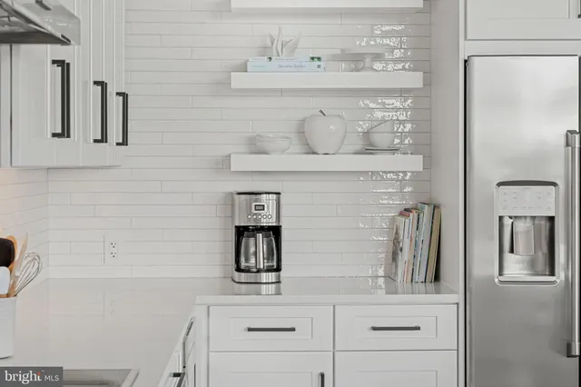 a bedroom with furniture and a large window