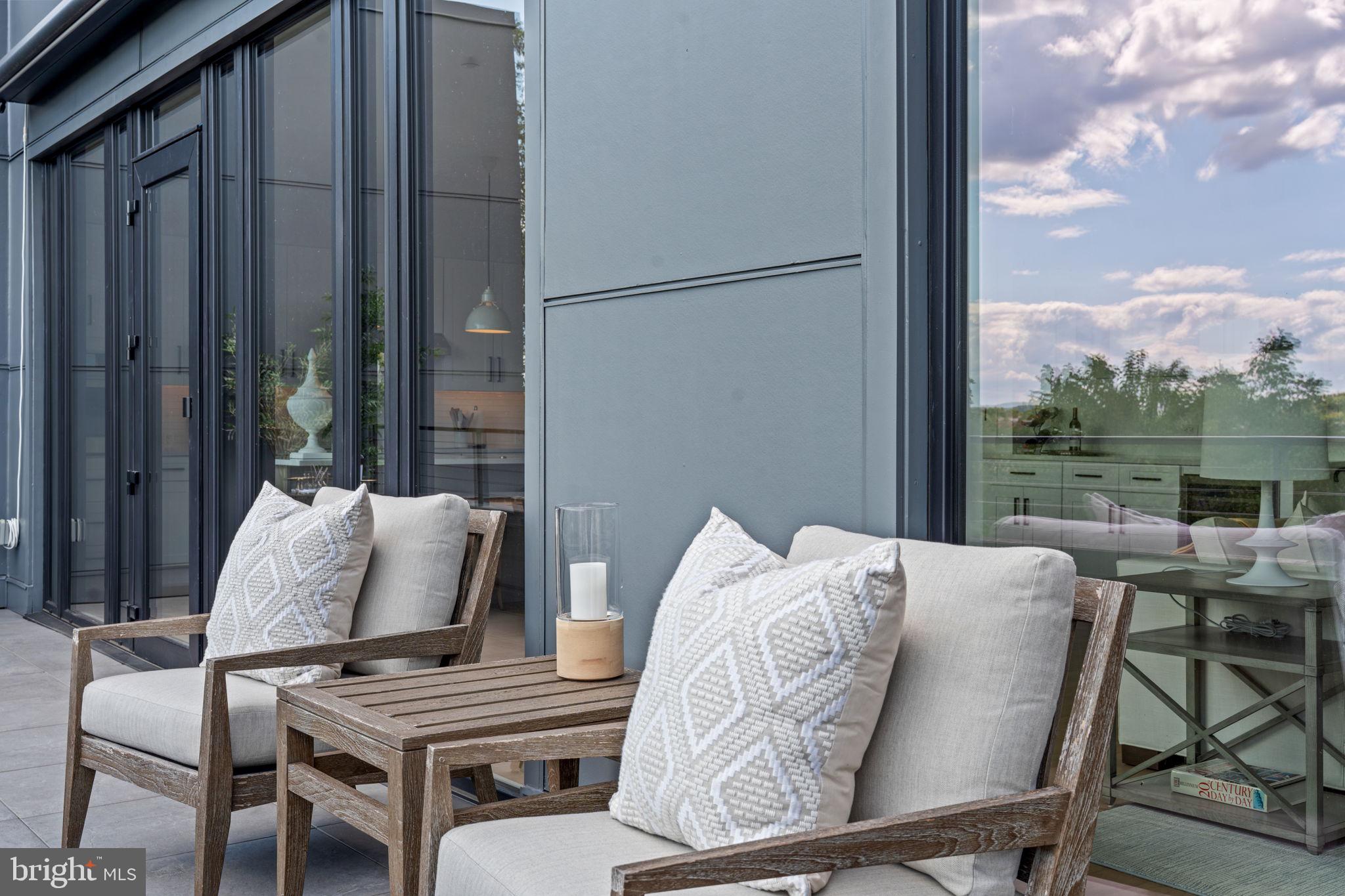 210 East 2nd Street, Unit 402 Frederick, MD 21701 - Photo 32 of 71 a balcony view with a glass top table and chairs