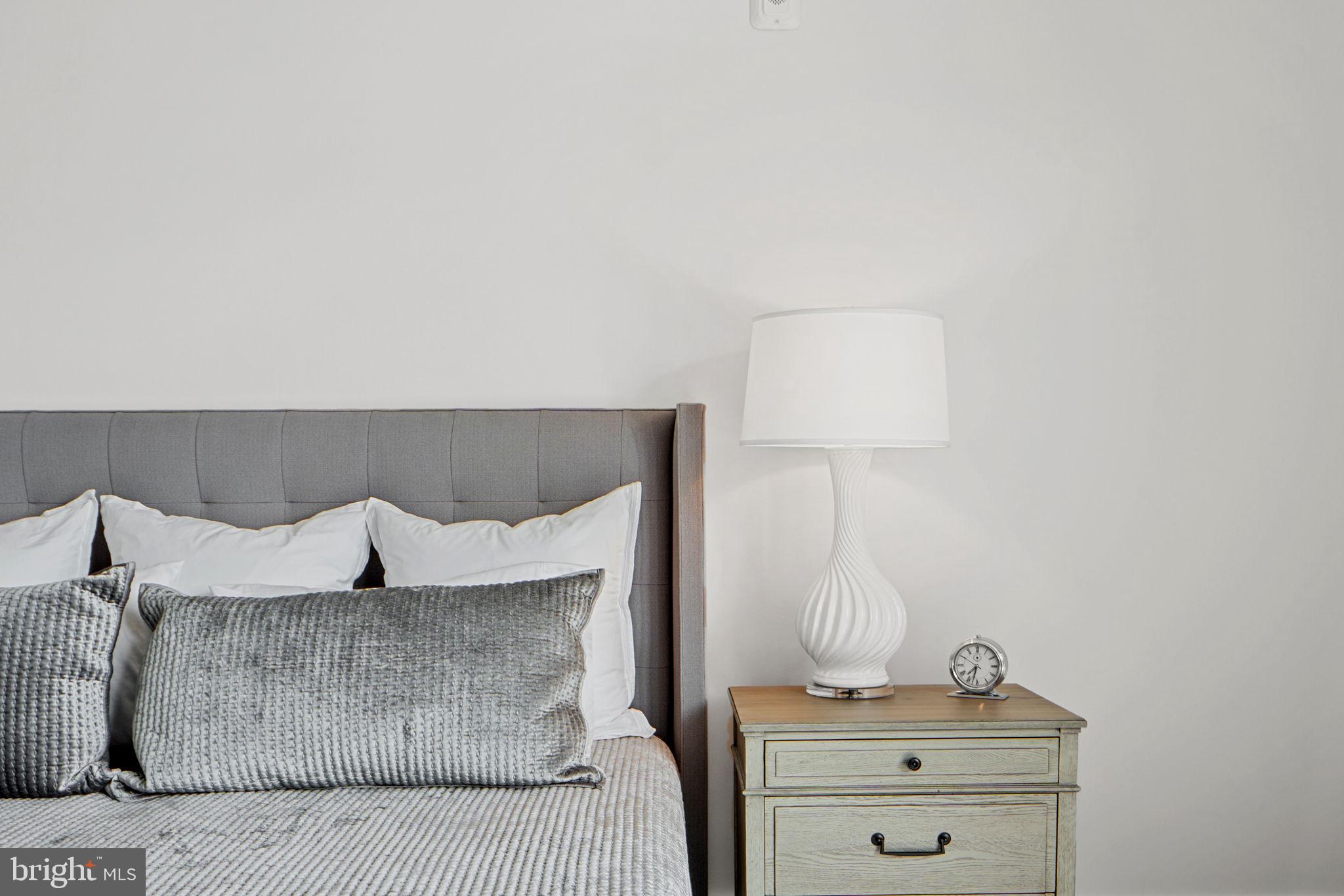 210 East 2nd Street, Unit 402 Frederick, MD 21701 - Photo 44 of 71 a bedroom with a bed and a night stand