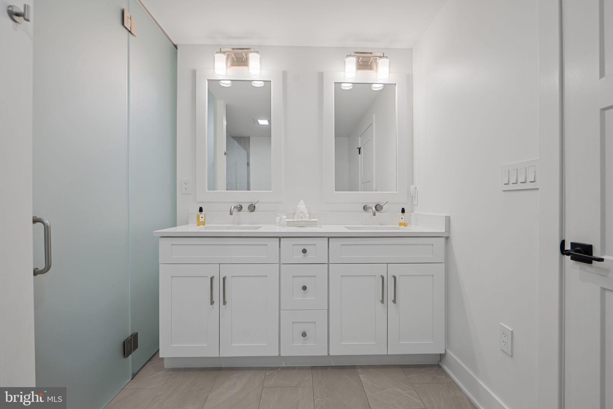 210 East 2nd Street, Unit 402 Frederick, MD 21701 - Photo 48 of 71 a bathroom with a sink and a mirror