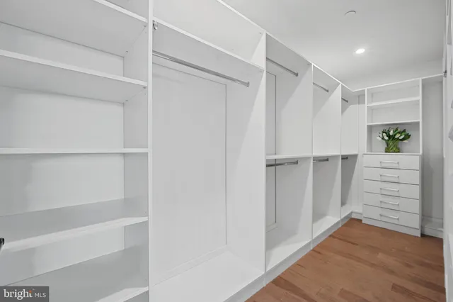 an aerial view of a city with lots of residential buildings and mountain view in back