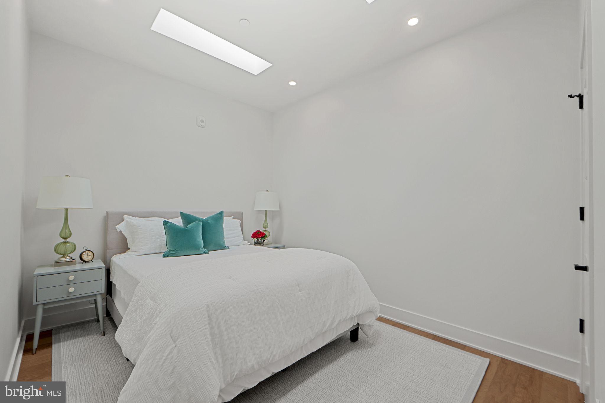 210 East 2nd Street, Unit 402 Frederick, MD 21701 - Photo 51 of 71 a bedroom with a bed and a lamp