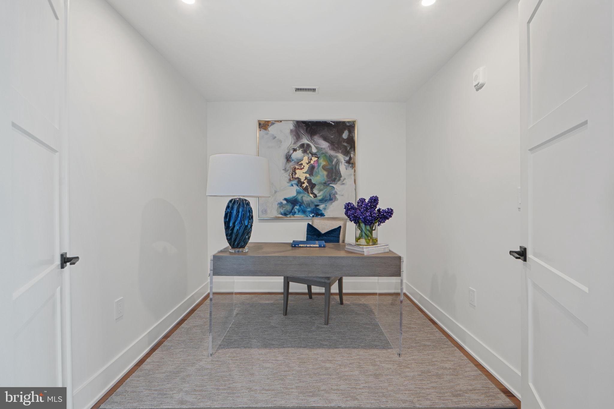 210 East 2nd Street, Unit 402 Frederick, MD 21701 - Photo 56 of 71 a view of a workspace with furniture and wooden floor