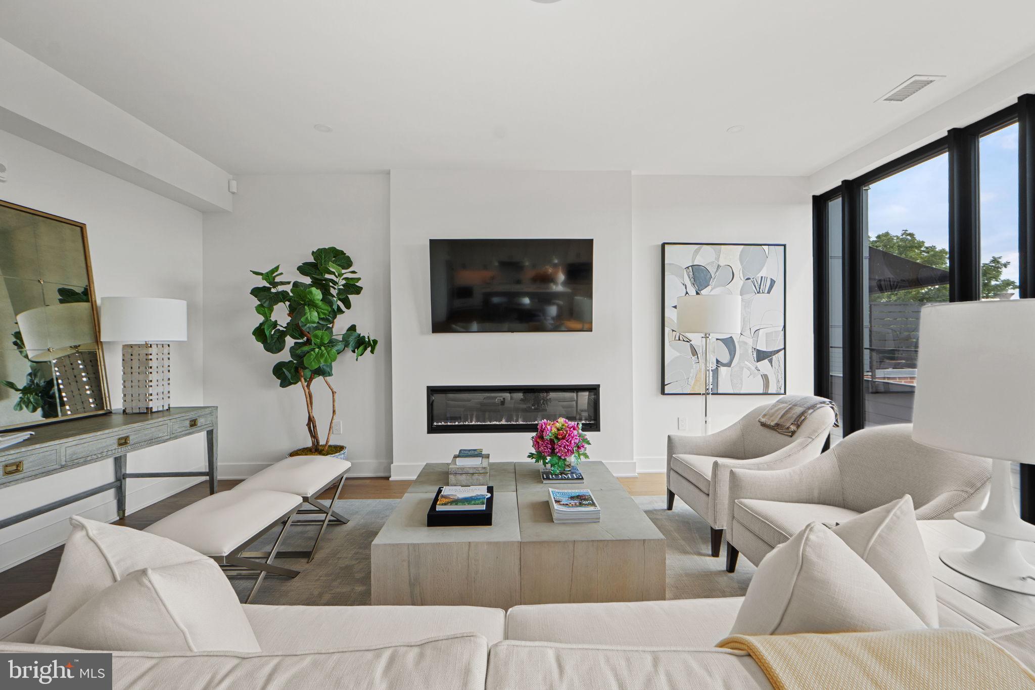 210 East 2nd Street, Unit 402 Frederick, MD 21701 - Photo 6 of 71 a living room with furniture a flat screen tv and a large window