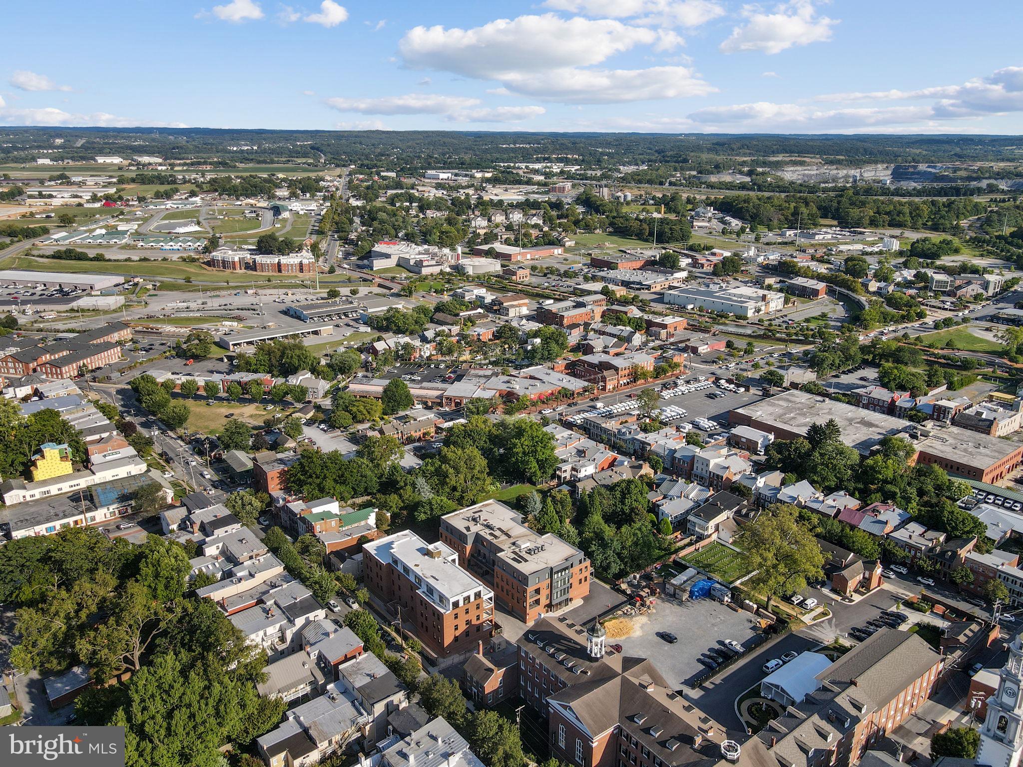 210 East 2nd Street, Unit 402 Frederick, MD 21701 - Photo 71 of 71 an aerial view of a city with lots of residential buildings and mountain view in back