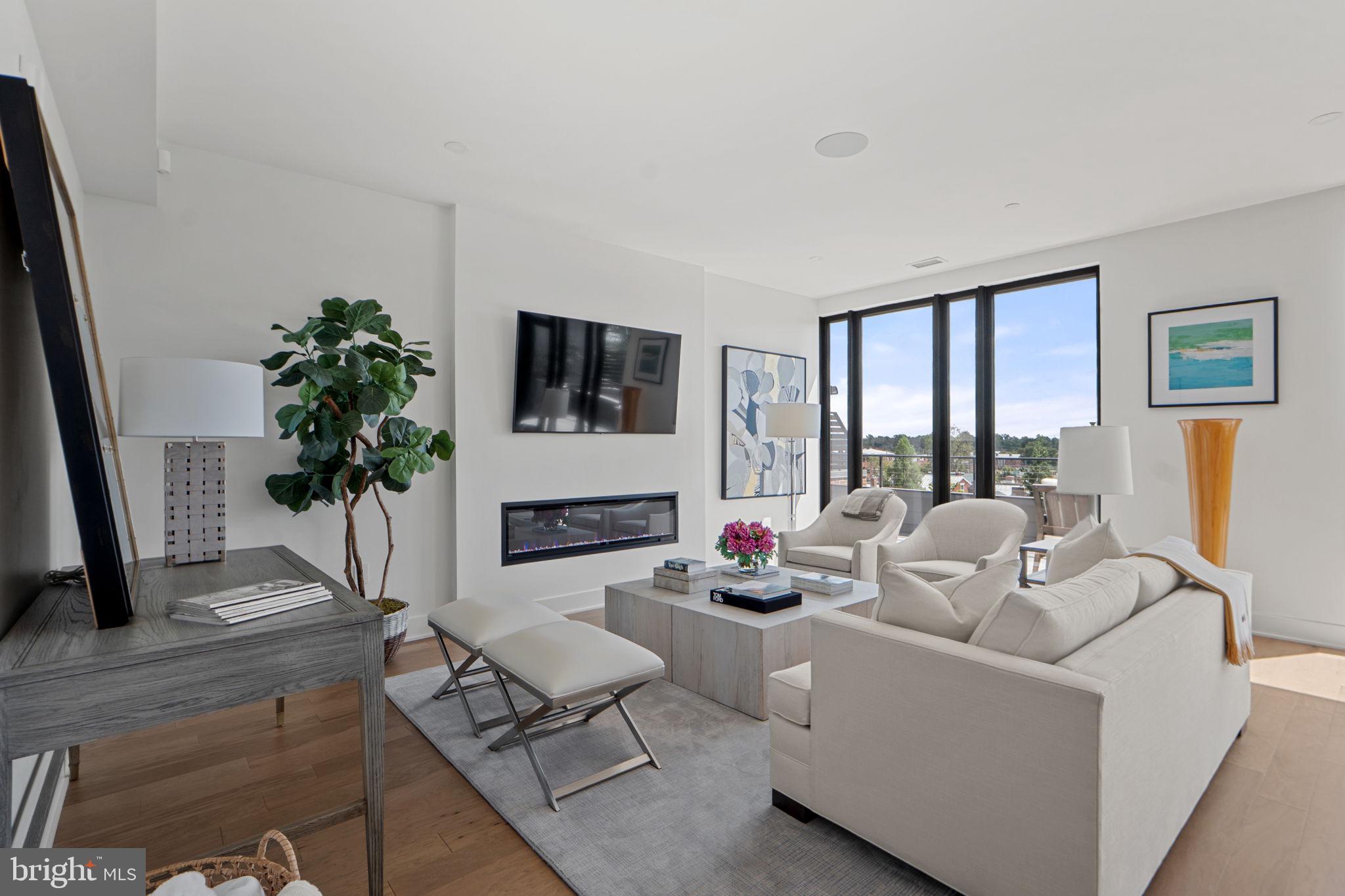 210 East 2nd Street, Unit 402 Frederick, MD 21701 - Photo 10 of 71 a living room with furniture a large window and a flat screen tv