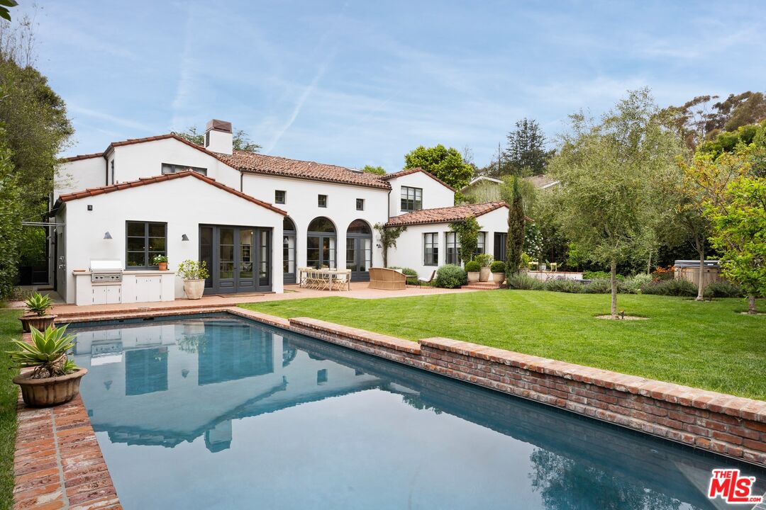a front view of a house with a yard table and chairs