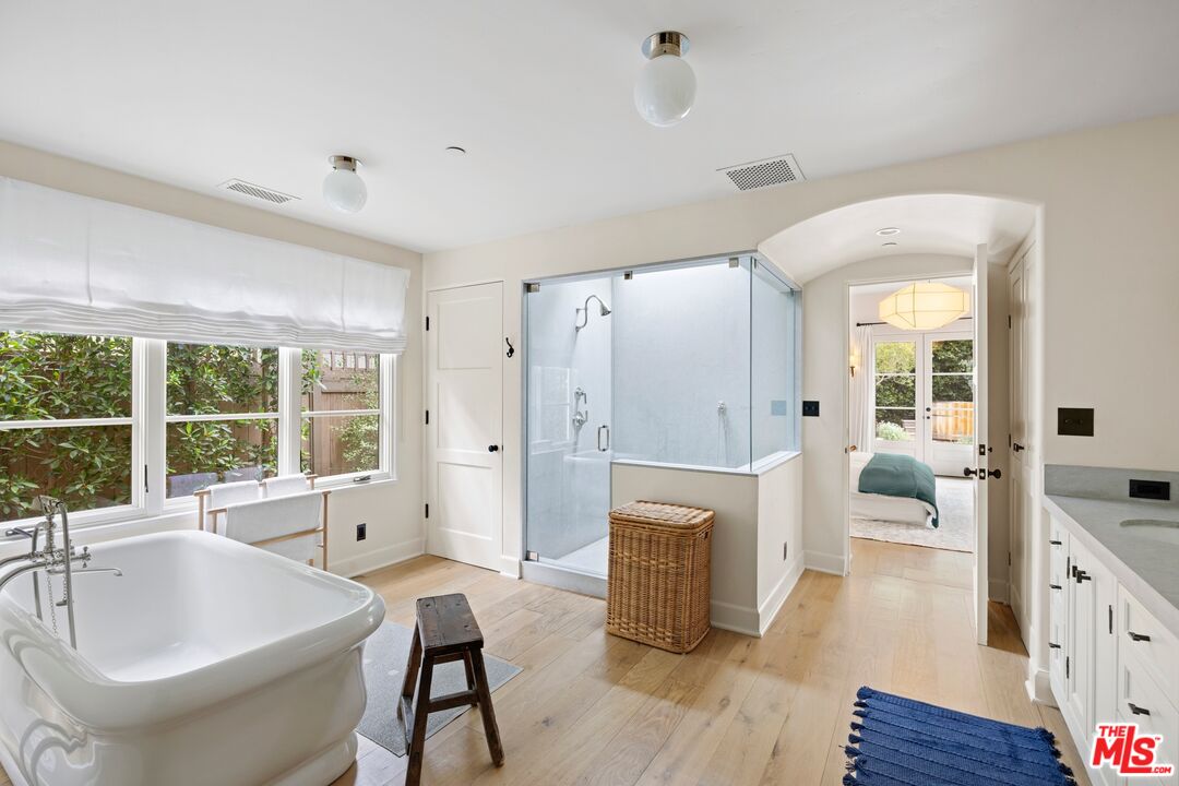 765 Ranch Lane Pacific Palisades, CA 90272 - Photo 11 of 23 a living room with furniture a fireplace and a large window