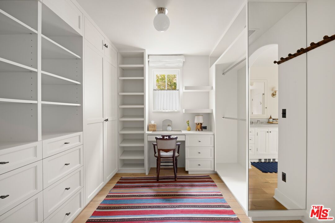 765 Ranch Lane Pacific Palisades, CA 90272 - Photo 12 of 23 a room with white cabinets and window