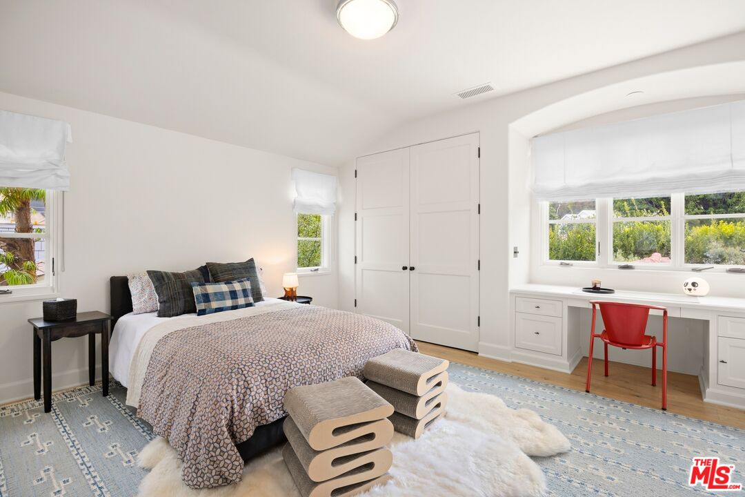 765 Ranch Lane Pacific Palisades, CA 90272 - Photo 13 of 23 a bedroom with a bed and a table