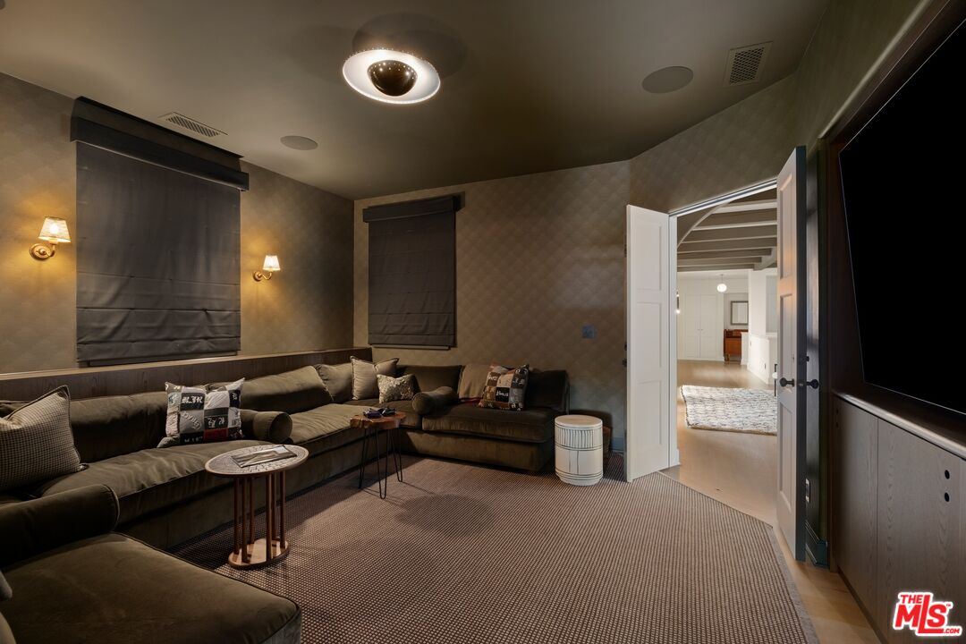 765 Ranch Lane Pacific Palisades, CA 90272 - Photo 19 of 23 a living room with furniture and a flat screen tv