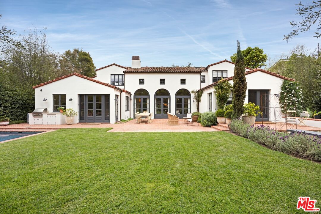 765 Ranch Lane Pacific Palisades, CA 90272 - Photo 22 of 23 a front view of a house with a yard porch and outdoor seating