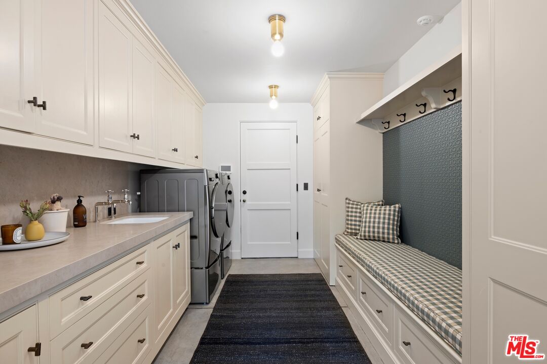 765 Ranch Lane Pacific Palisades, CA 90272 - Photo 23 of 23 a hallway with white cabinets and wooden floor
