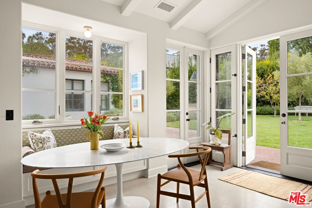765 Ranch Lane Pacific Palisades, CA 90272 - Photo 8 of 23 a dining room with furniture a chandelier and wooden floor