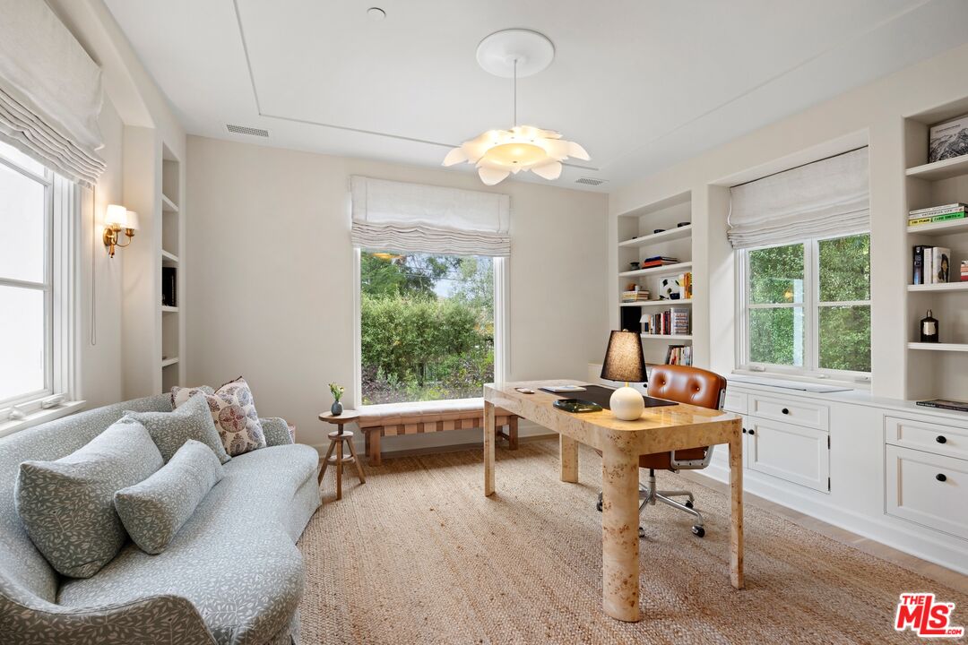 765 Ranch Lane Pacific Palisades, CA 90272 - Photo 9 of 23 a work room with furniture and a chandelier