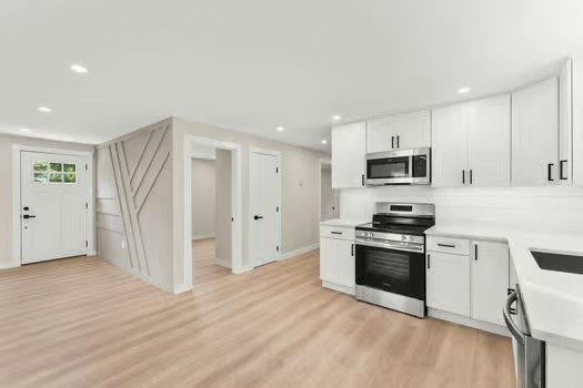 7 Edward Street Canton, MA 02021 - Photo 2 of 22 a kitchen with stainless steel appliances granite countertop a stove a sink and a refrigerator