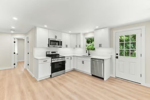 7 Edward Street Canton, MA 02021 - Photo 3 of 22 a kitchen with white cabinets and appliances