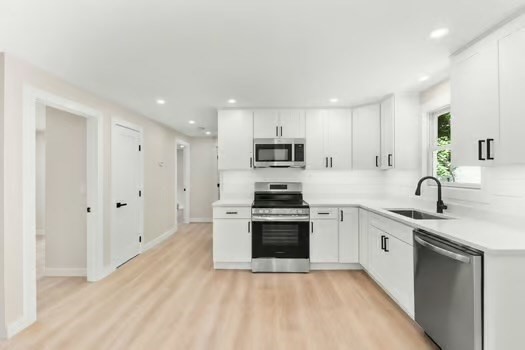 7 Edward Street Canton, MA 02021 - Photo 4 of 22 a large kitchen with cabinets stainless steel appliances and a sink