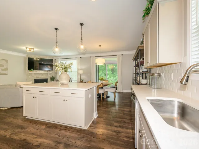 a kitchen with a sink stove and wooden cabinets