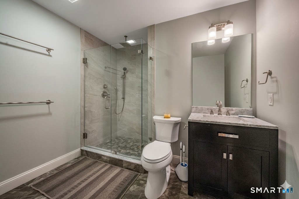 28 Walden Hill Road Guilford, CT 06437 - Photo 27 of 35 a bathroom with a sink toilet and shower