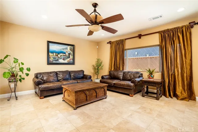 a living room with furniture and a large window with garden view