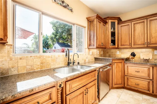 a kitchen with granite countertop a sink and a window
