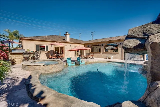 a view of a patio with dining table and chairs with a yard
