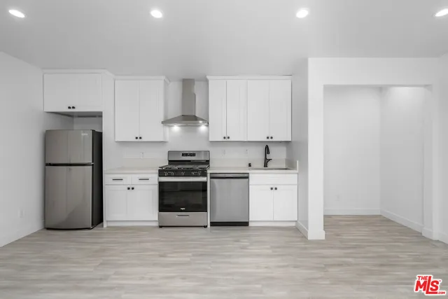 a kitchen with a white stove top oven and refrigerator
