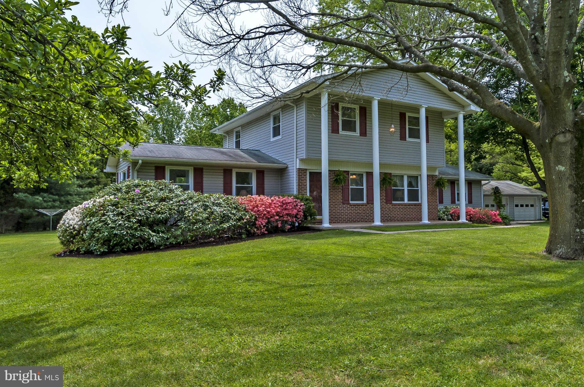 12955 Triadelphia Mill Road Clarksville, MD 21029 - Photo 2 of 29 a front view of a house with a garden