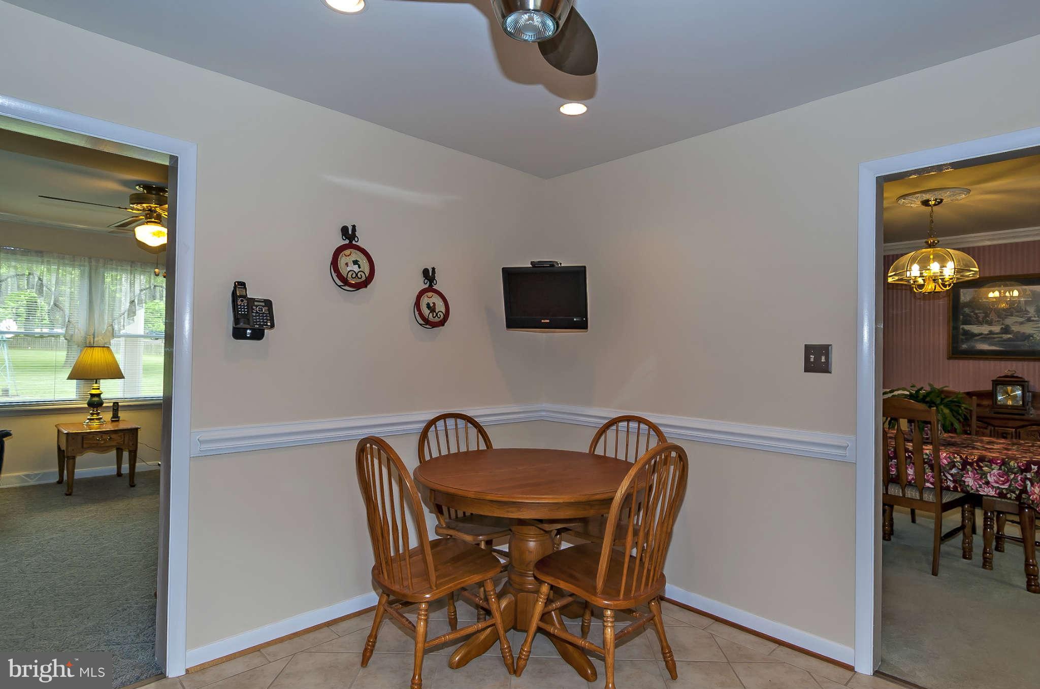 12955 Triadelphia Mill Road Clarksville, MD 21029 - Photo 11 of 29 a view of a dining room with furniture and chandelier