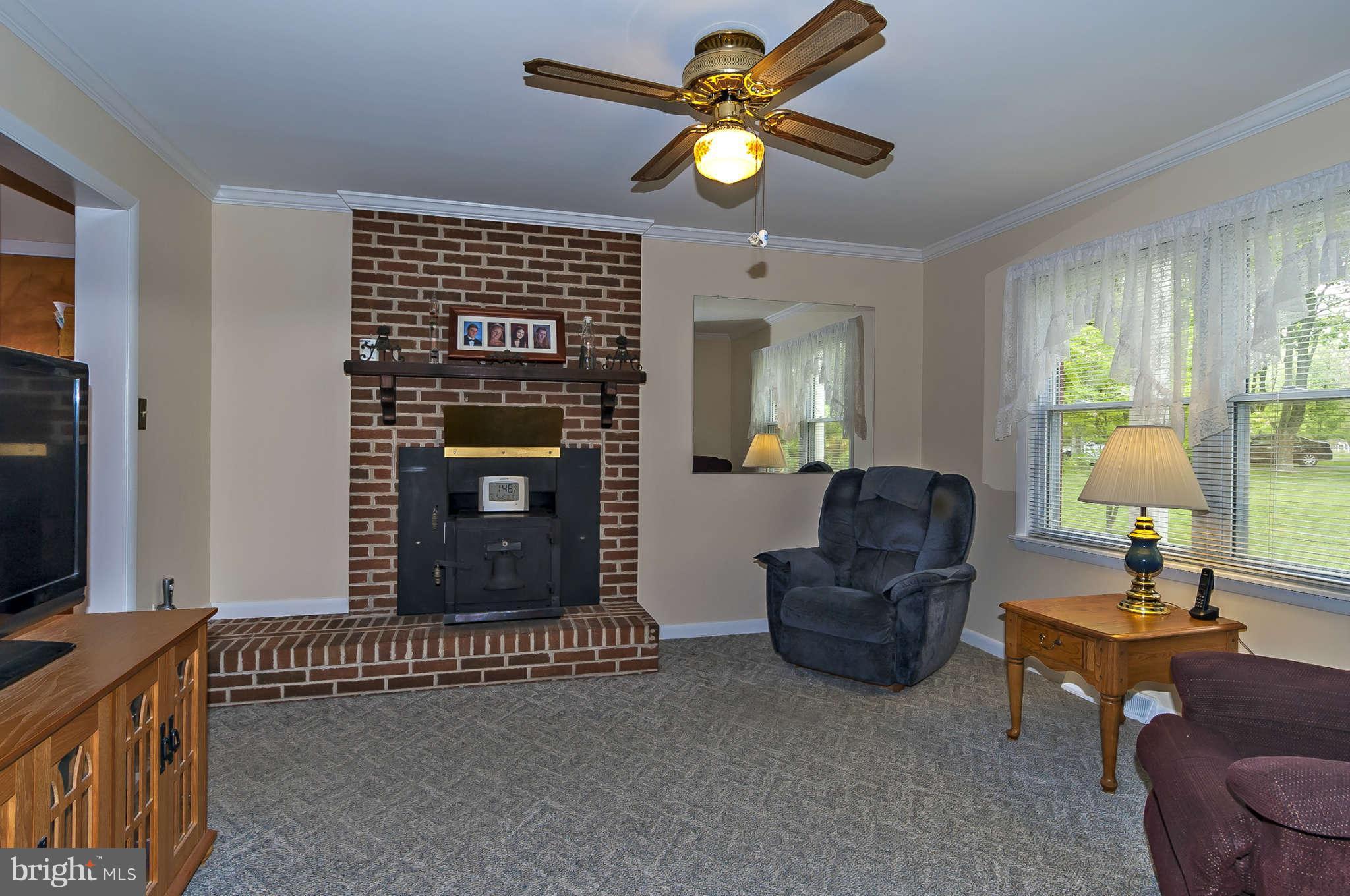 12955 Triadelphia Mill Road Clarksville, MD 21029 - Photo 12 of 29 a living room with furniture and a fireplace