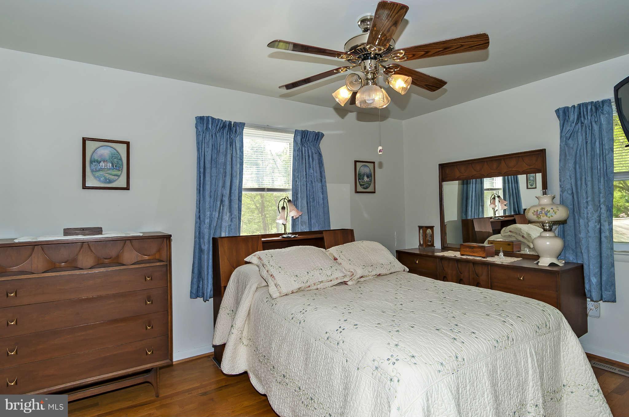 12955 Triadelphia Mill Road Clarksville, MD 21029 - Photo 13 of 29 a bedroom with a bed and a chandelier
