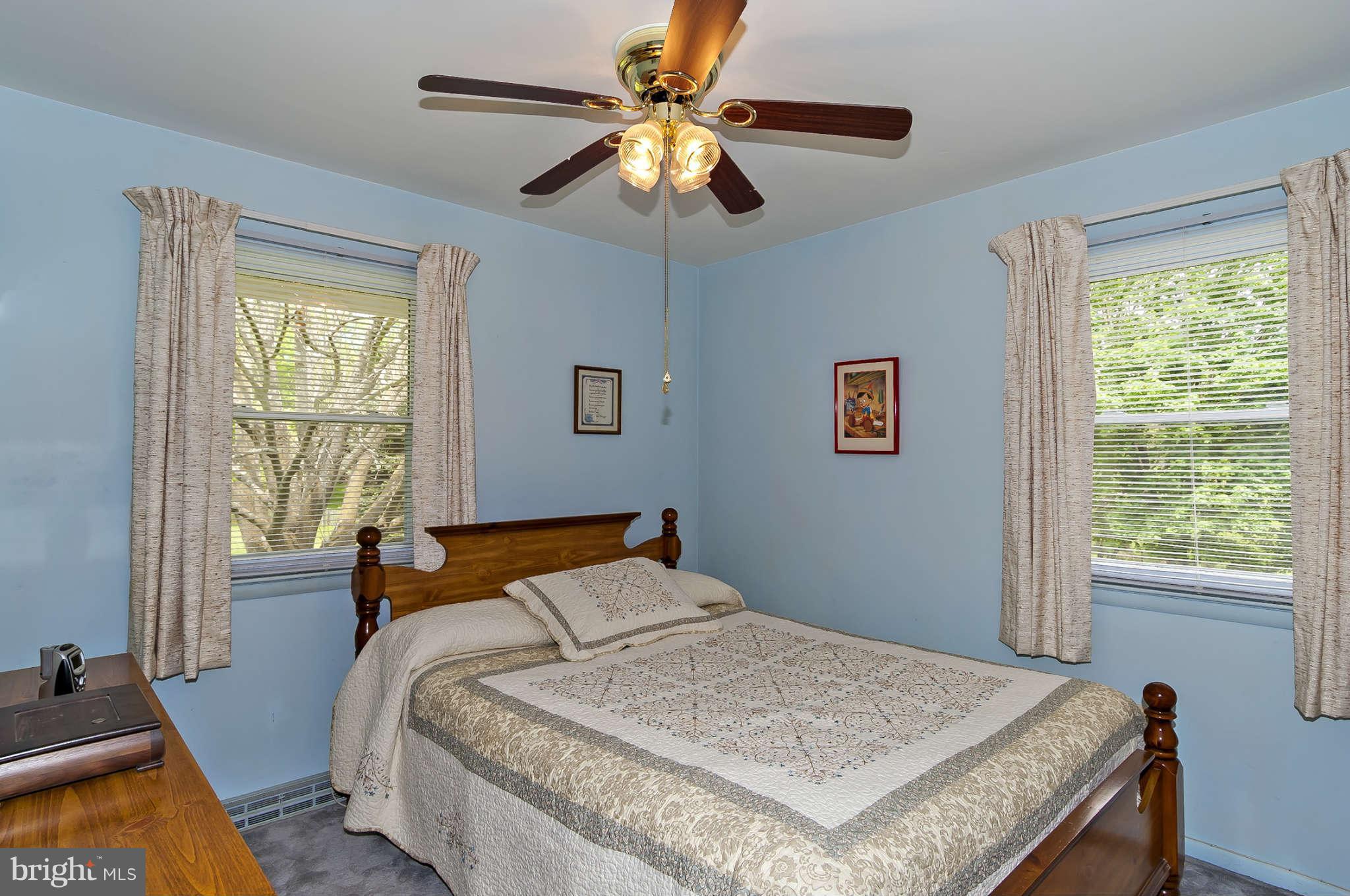 12955 Triadelphia Mill Road Clarksville, MD 21029 - Photo 14 of 29 a bedroom with a bed and a chandelier