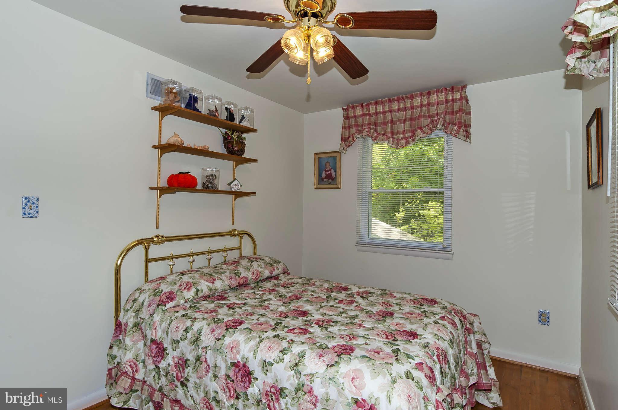 12955 Triadelphia Mill Road Clarksville, MD 21029 - Photo 15 of 29 a bedroom with a bed and a chandelier