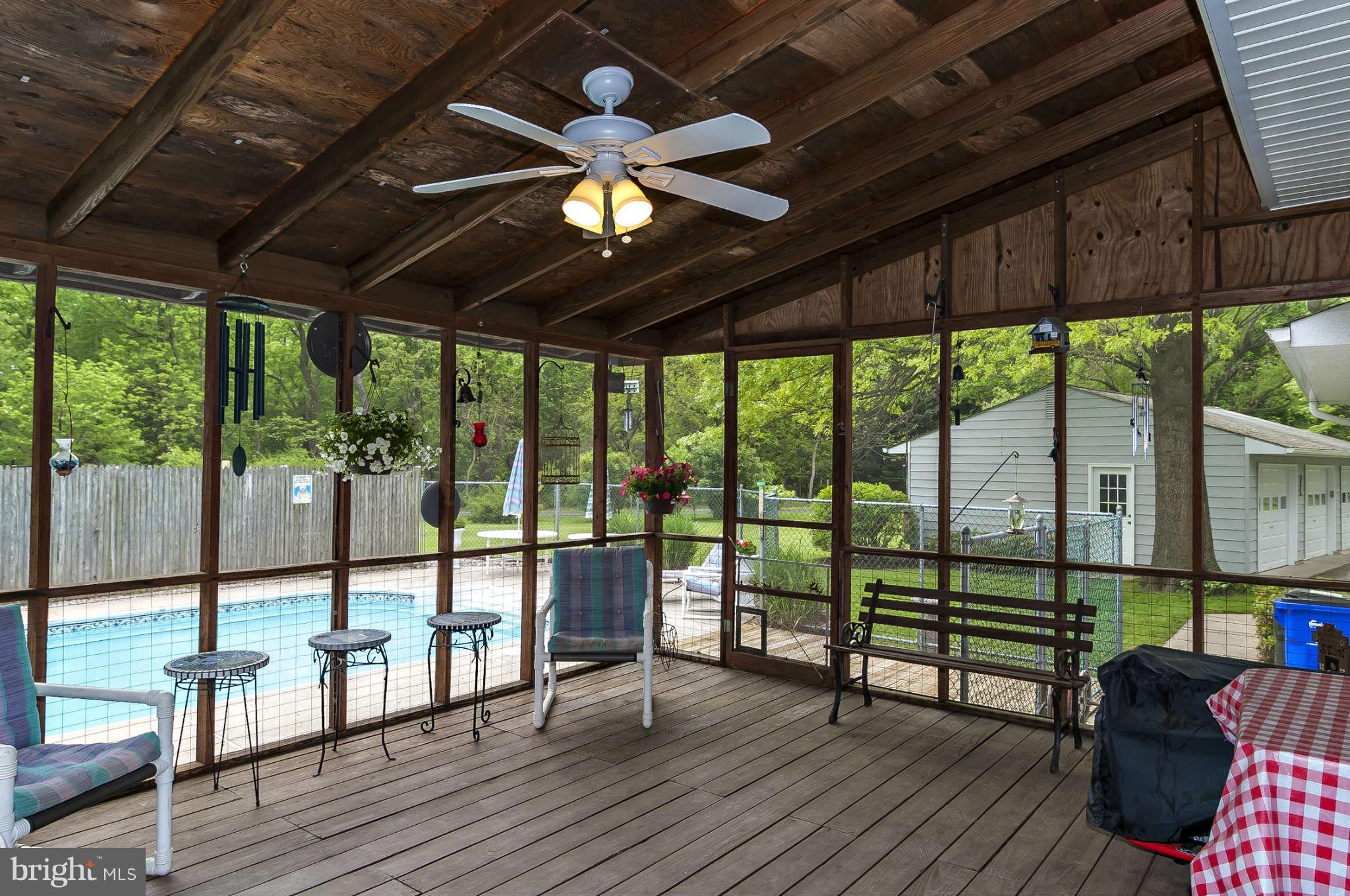 12955 Triadelphia Mill Road Clarksville, MD 21029 - Photo 17 of 29 a view of a porch with wooden floor and outdoor seating