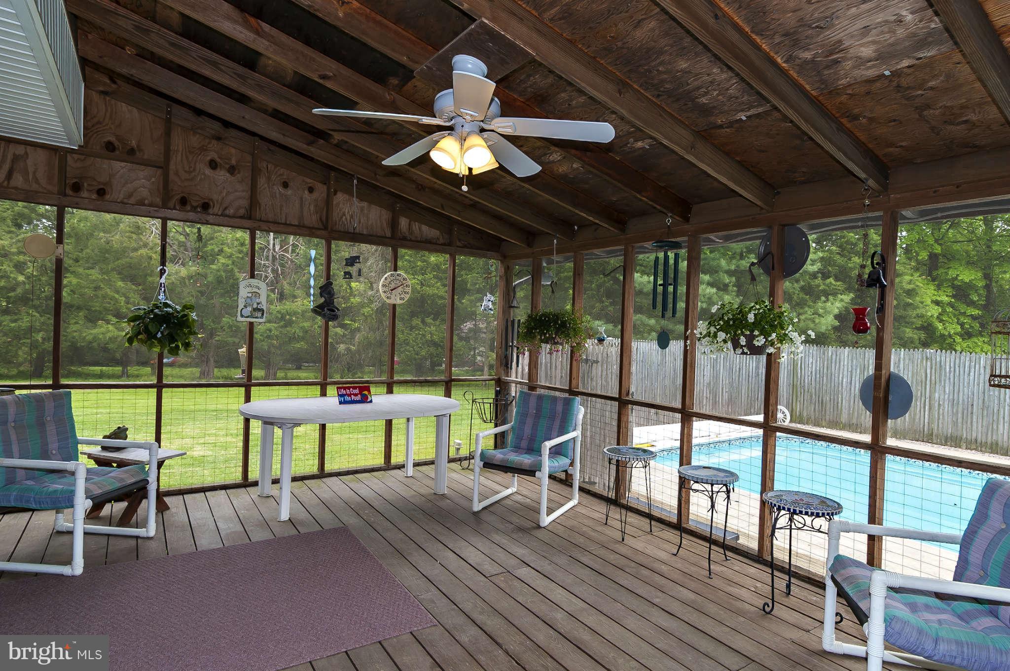 12955 Triadelphia Mill Road Clarksville, MD 21029 - Photo 18 of 29 a view of a patio with a table chairs and a backyard