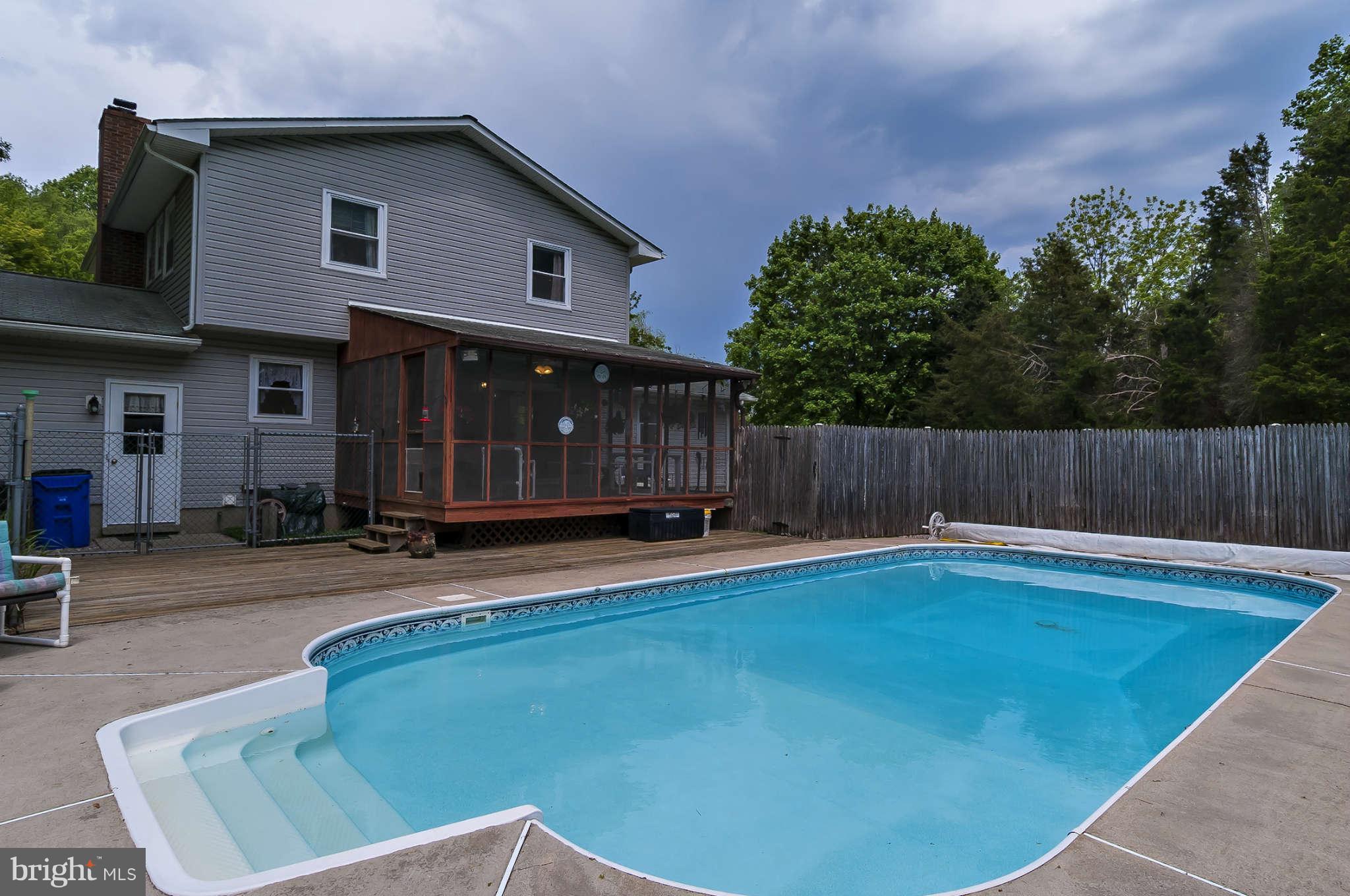 12955 Triadelphia Mill Road Clarksville, MD 21029 - Photo 19 of 29 a view of backyard with deck and outdoor seating